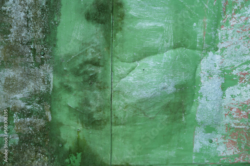 Painted green surface of old peeling paint background. High quality photo