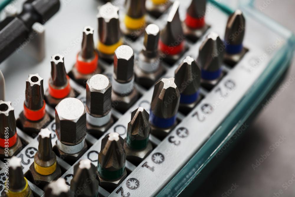 A set of bits in a box in a row with a close-up repair and maintenance kit A set of bits in a box in a row with a close-up repair and maintenance kit