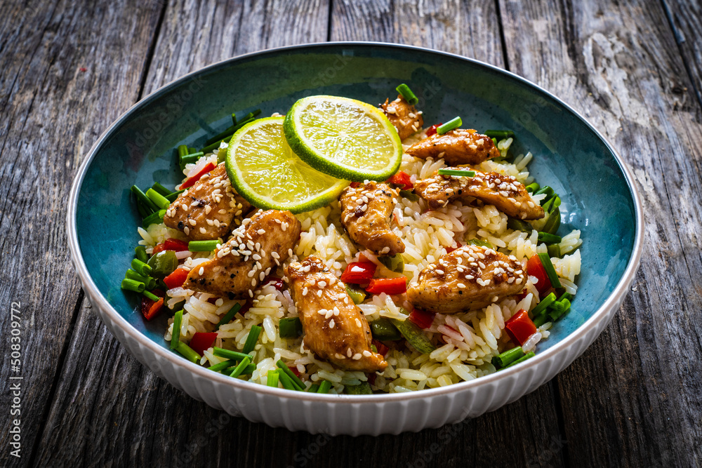 Teriyaki chicken nuggets with rice and vegetables on wooden table
Teriyaki chicken nuggets with rice and vegetables on wooden table
