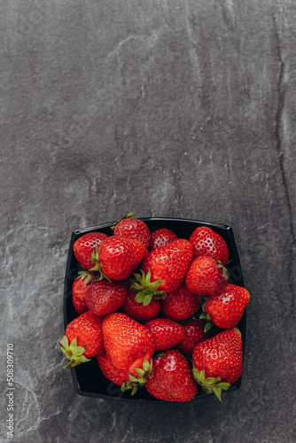 Fresh strawberries in plate, fruits on farmer market table