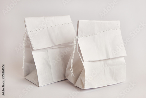 Paper bag with coffee beans, sewn with thread. Dry food packaging.