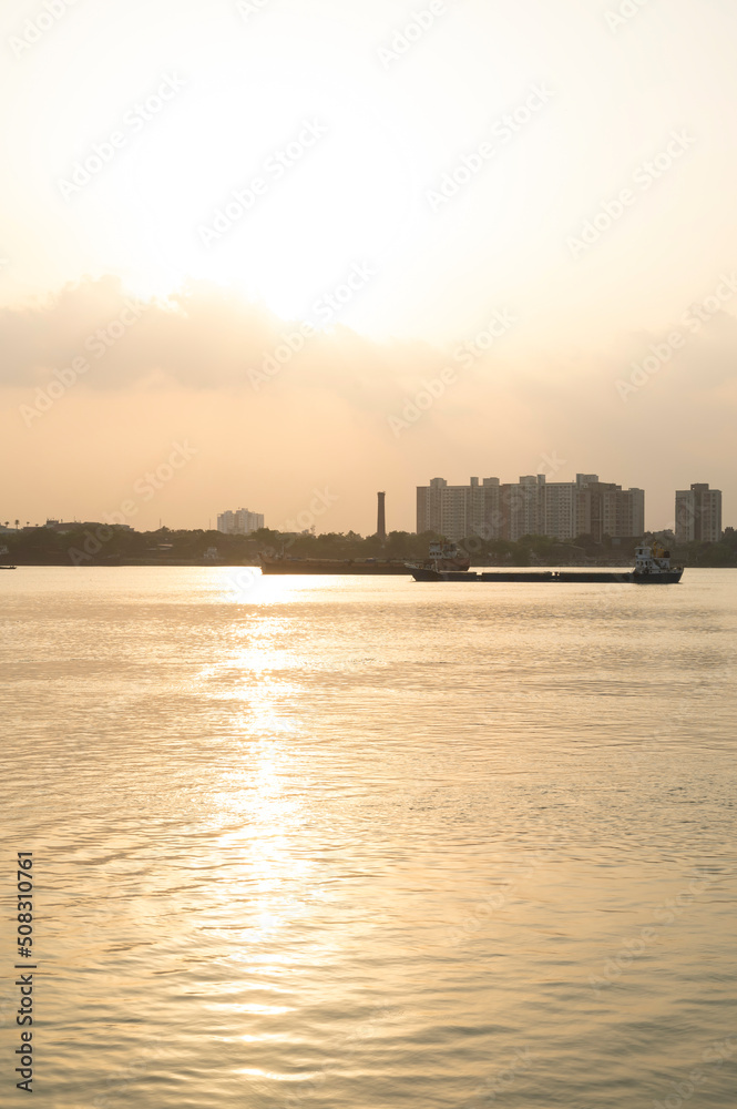 Sunray reflect on the Ganga River beside Hooghly Bridge. Princep Ghat at Kolkata. Beautiful sunset. A beautiful scene Howrah and Ganga river from Princep Ghat at Kolkata. Sunray reflect on the Ganga River beside Hooghly Bridge. Princep Ghat at Kolkata. Beautiful sunset. A beautiful scene Howrah and Ganga river from Princep Ghat at Kolkata.