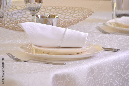 Тable setting in beige shades in a restaurant
