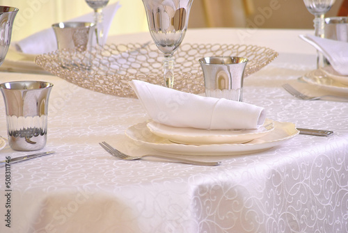Тable setting in beige shades in a restaurant