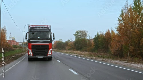 Wallpaper Mural New modern truck is driving on suburban multi-lane road. Truck getting closer to the camera. Close-up of the front of the truck. Torontodigital.ca
