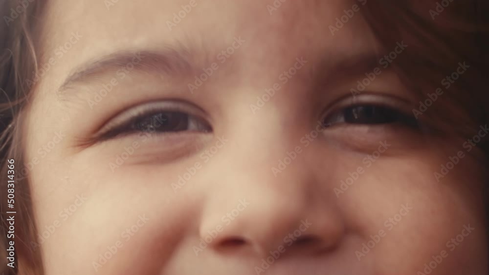 Toddler enjoying a beautiful spring, summer day outside on the patio. 4K footage. Extreme closeup. Toddler enjoying a beautiful spring, summer day outside on the patio. 4K footage. Extreme closeup.