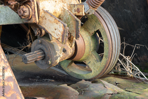 Old round rusty wheel agricultural machinery. Steampunk spokes. High quality photo