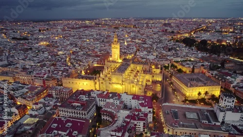 Flying around the famous gothic Cathedral in Seville at night, Andalusia, Spain