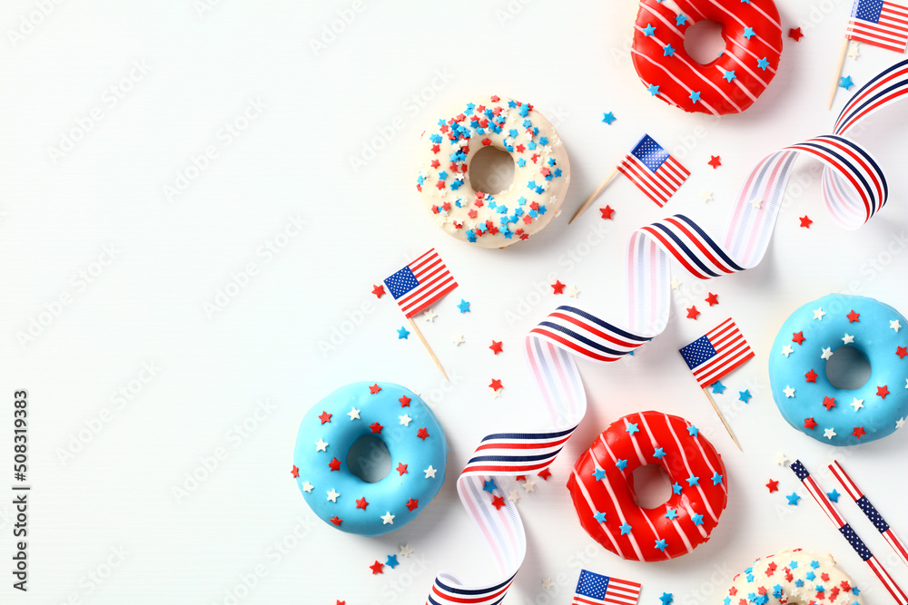 Flat lay doughnuts in colors of American flag and decorations isolated on white background. Happy Independence Day, Labor day, Presidents Day in US concept.