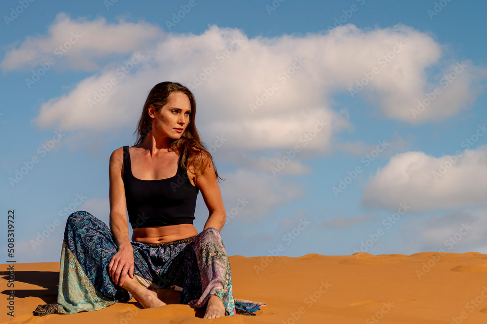 A Beautiful Model Poses In The Sand Dunes In The Great Sahara Desert In Morocco, Africa