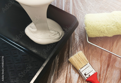 tools for painting and apartment renovation. Brush, roller and white paint