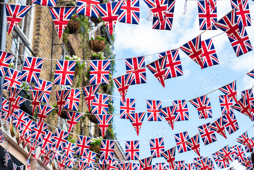 Union Jack flags on the street during queens jubilee celebration. Street party decorations in the UK city. Selective focus  photo