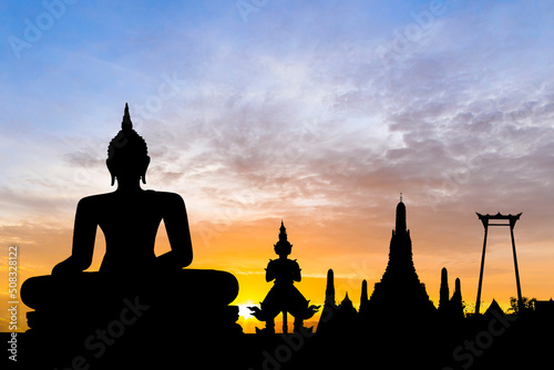 Silhouette with buddha on sunset background. © wasanajai