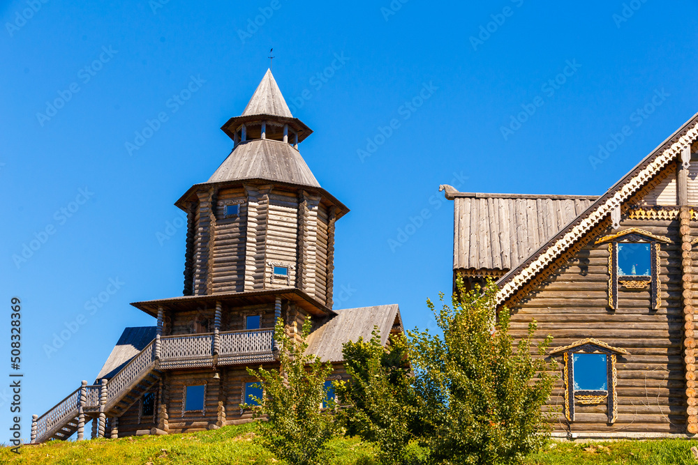 Old Slavic tower of the Sun in the old village. Wooden religious pagan tower for prayers. Russian village. Old Slavic tower of the Sun in the old village. Wooden religious pagan tower for prayers. Russian village.