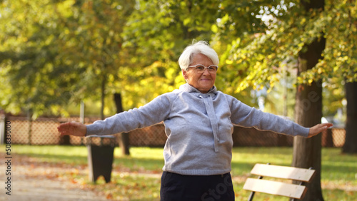 middle aged Caucasian woman works out in park medium shot copy space . High quality photo
