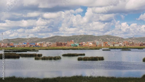 View Of The Lake With Reeds, Town And The Mountain Range In The Distance photo