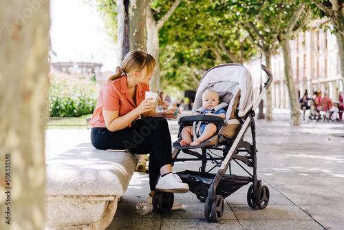 young mother takes a walk with young baby
