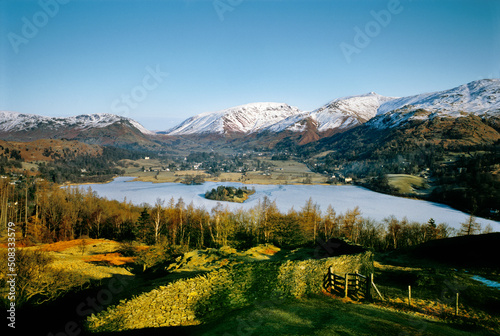 North over Grasmere valley village in Lake District National Park, Cumbria, England. Frozen lake and snow on mountains. Winter. © David Matthew Lyons