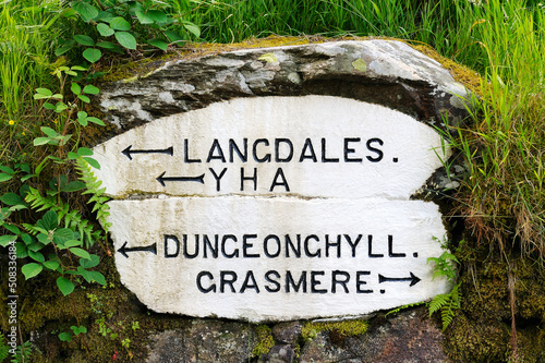 Old road sign directions to Langdales, Dungeon Ghyll, YHA at Red Bank, Grasmere. Lake District National Park, Cumbria, England. photo
