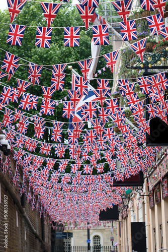 British Union Jack flag triangular hanging in preparation for a street party. Festive decorations of Union Jack bunting. Selective focus  photo