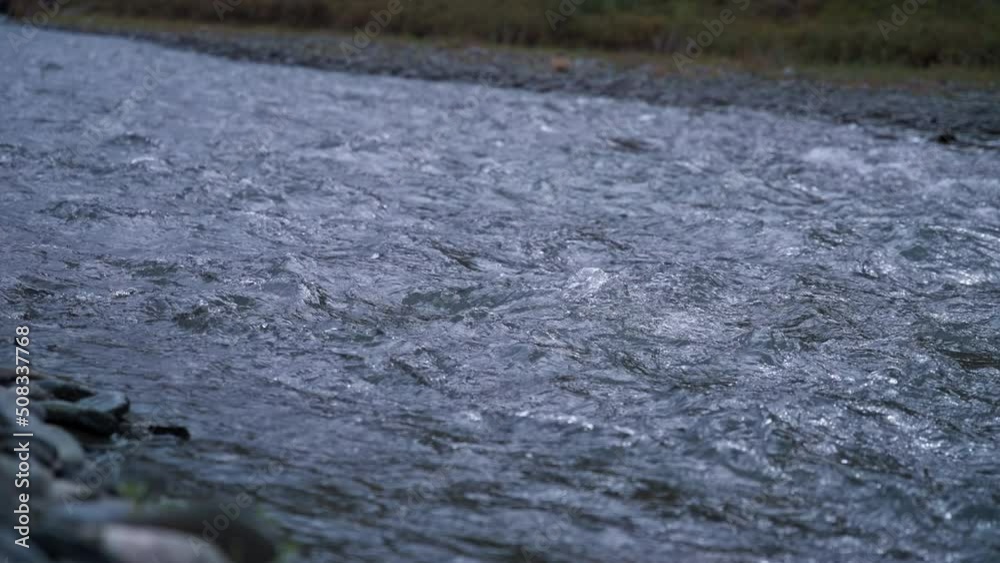 Wild mountain river flowing through stone rapids. Slow motion. Wild mountain river flowing through stone rapids. Slow motion.