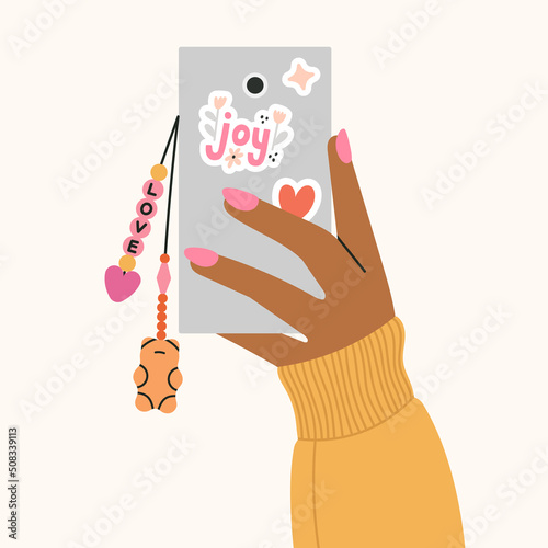 Cute poster with girl's hand holding a phone with a beaded key chain. Beading, handmade, fashion concept. 
Hand drawn vector illustration in trendy colors isolated on beige background.