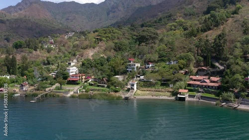 Wallpaper Mural Aerial drone forwarding shot over hotels, resorts and residential houses on the banks of lake Atitlan, Guatemala, Central America surrounded by volcanic mountain range. Torontodigital.ca