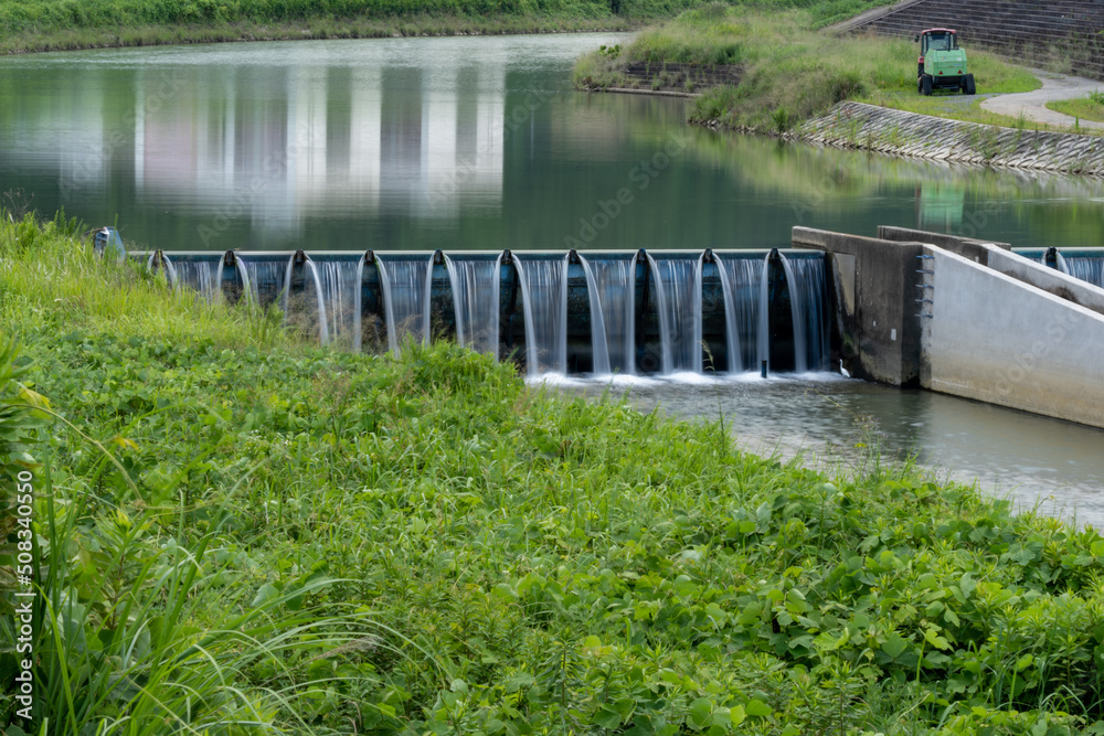 Wall Mural Water is falling from stream weir in countryside, JAPAN.