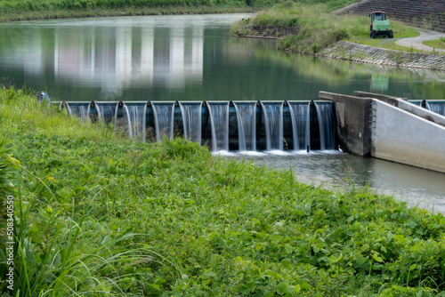 Water is falling from stream weir in countryside, JAPAN.