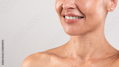 Tech Neck Treatments. Unrecognizable Middle Aged Woman With Beautiful Skin, Cropped Shot photo
