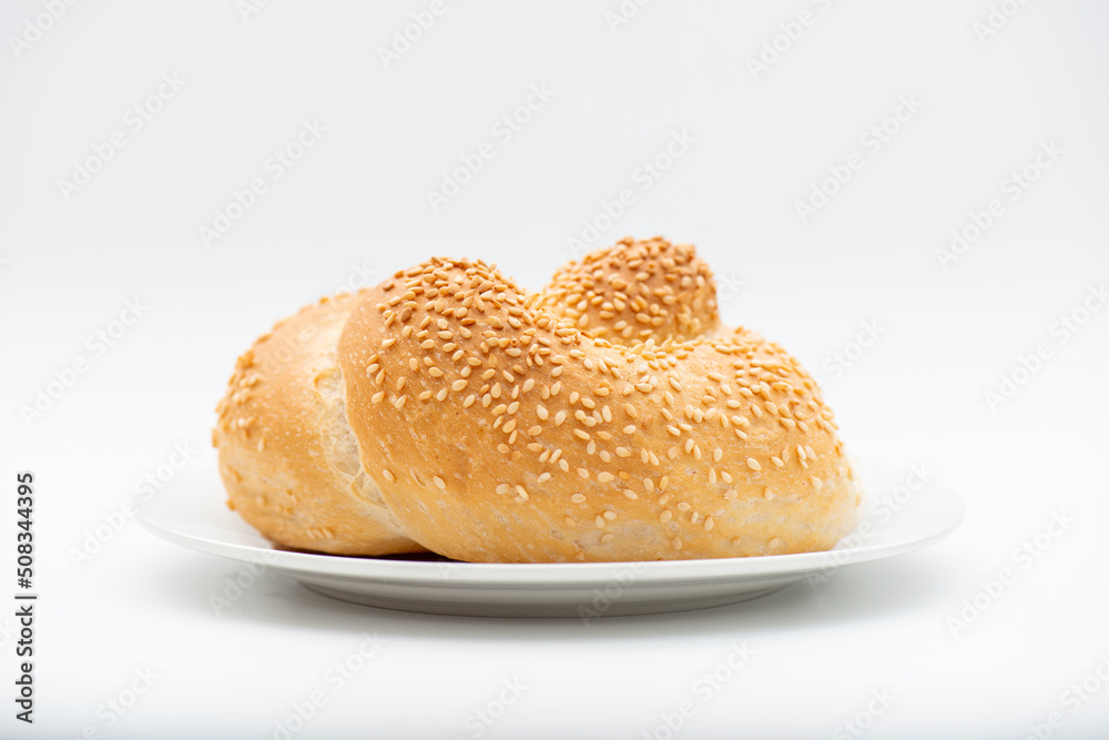 Delicious fresh baked knot bread roll with sesame seeds