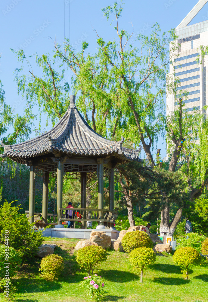 Changchun, Jilin - April 3 2021: Chinese pavilion architecture in a city park in summer.