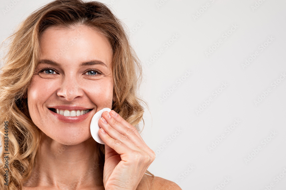 Makeup Removal. Beautiful Happy Middle Aged Lady Cleaning Face With Cotton Pad Makeup Removal. Beautiful Happy Middle Aged Lady Cleaning Face With Cotton Pad