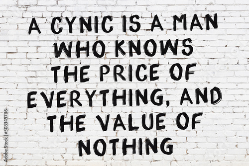 White brick wall with painted black inscription of wise quote