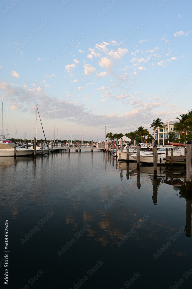 Suummer cloudscape reflected in tranquil water of Dinner Key Marina in Coconut Grove, Miami, Florida.