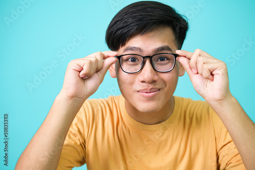 Smiling young man wearing glasses look at camera