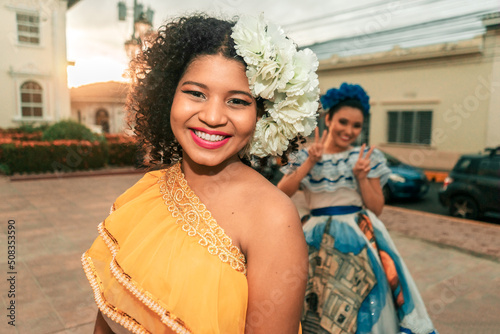 Photos Two traditional dancers with the typical Nicaraguan costume having fun, goofing around and fooling around during sunset on a street in Leon Nicaragua