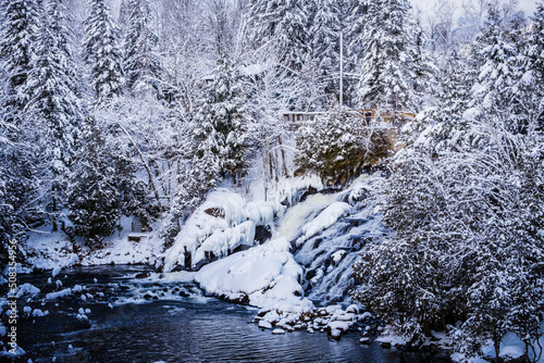 View on Devil's river waterfall (Chute de la rivière au Diable) under the snow during winter, located near Mont Tremblant in Quebec (Canada)