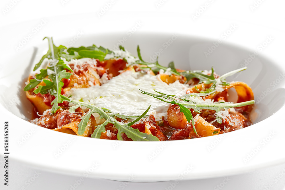Italian pasta pappardelle with bolognese sauce  and parmesan isolated on white background. Pasta tagliatelle with meat ragu and creamy espuma with arugula. Minced beef in tomato sauce with pasta.
