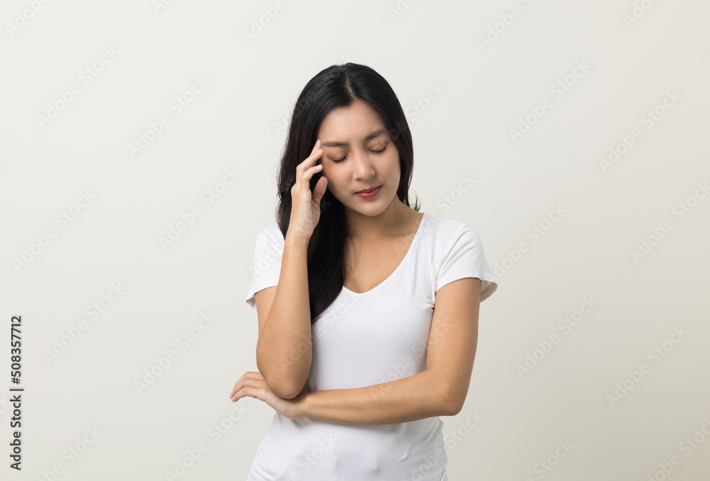 Young asian beautiful woman hand touching head she's feeling depressed stress headache be tired from working standing on isolated white background she has symptom office syndrome. Young asian beautiful woman hand touching head she's feeling depressed stress headache be tired from working standing on isolated white background she has symptom office syndrome.