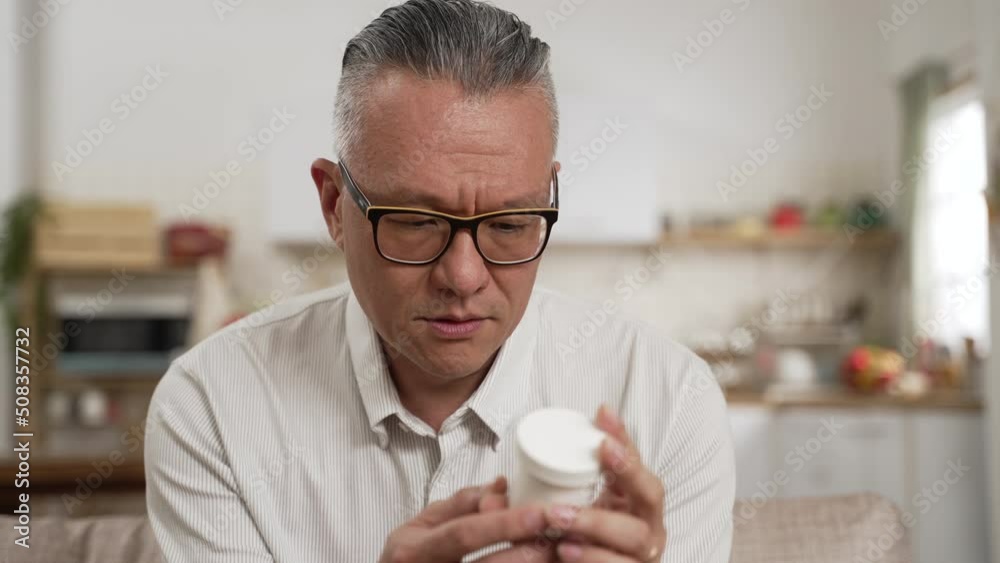 confused asian senior Japanese man with bad memory looking at a white container in hand and can’t remember if he has taken the pill at home. memory loss in Alzheimer’s concept confused asian senior Japanese man with bad memory looking at a white container in hand and can’t remember if he has taken the pill at home. memory loss in Alzheimer’s concept
