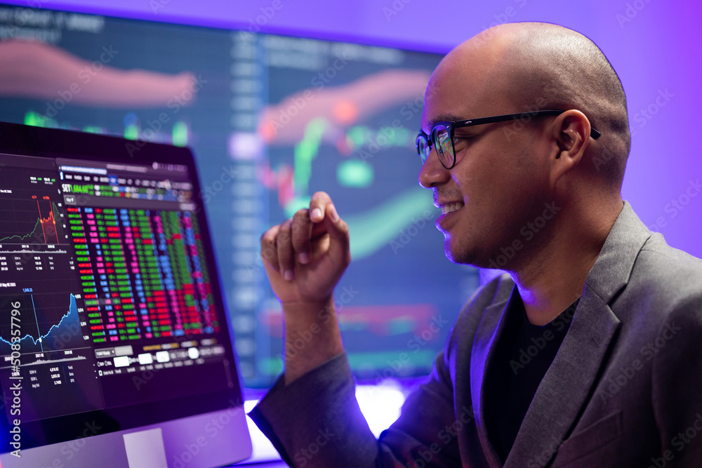 Investor businessman analyzing a graphic of a stock cryptocurrency exchange chart and looks at computer monitor. Financial analyst working with real-time exchange rate diagram. Investment concept Investor businessman analyzing a graphic of a stock cryptocurrency exchange chart and looks at computer monitor. Financial analyst working with real-time exchange rate diagram. Investment concept