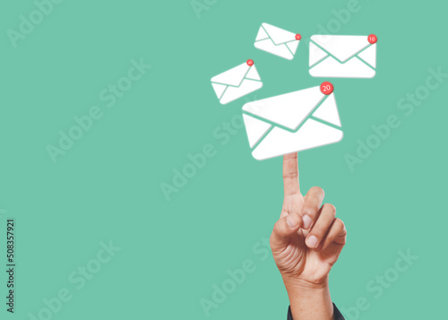 Sending email contact network concept. Hands finger touch pointing email contact icons green background, communication message send and receive. photo