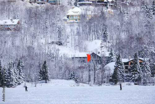 People snowkiting on a cold winter day on Lake Tremblant near Tremblant ski resort in Quebec (Canada) photo