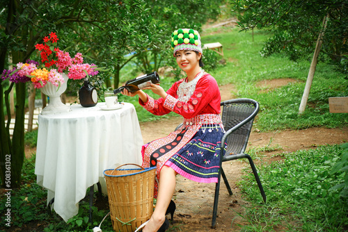 Tribal farmer woman background drinking juice in outdoor orange orchard.