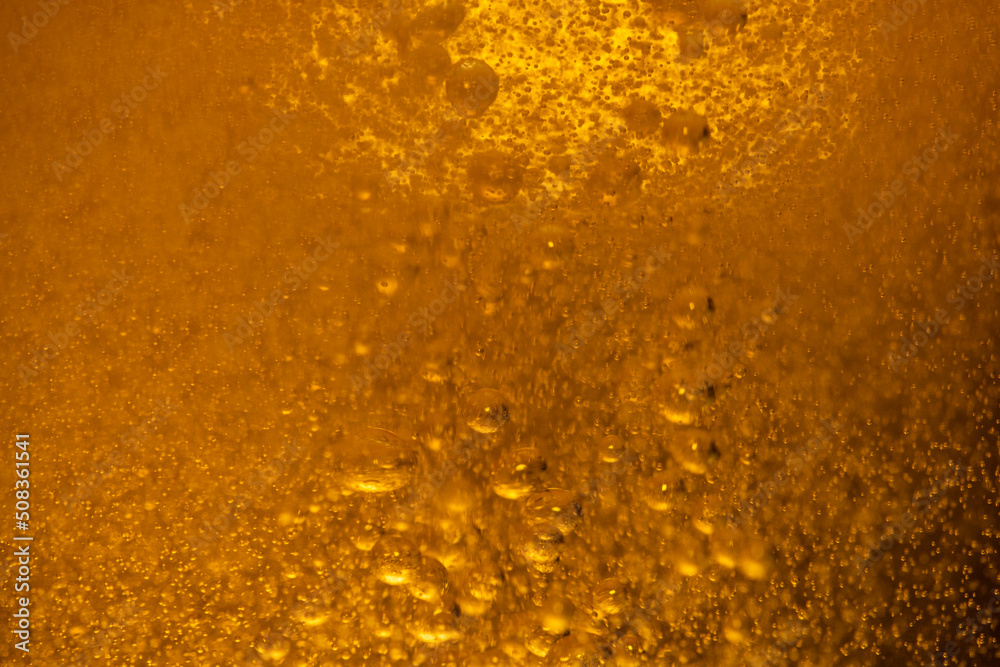 Lager beer bubbles close up motion abstract background