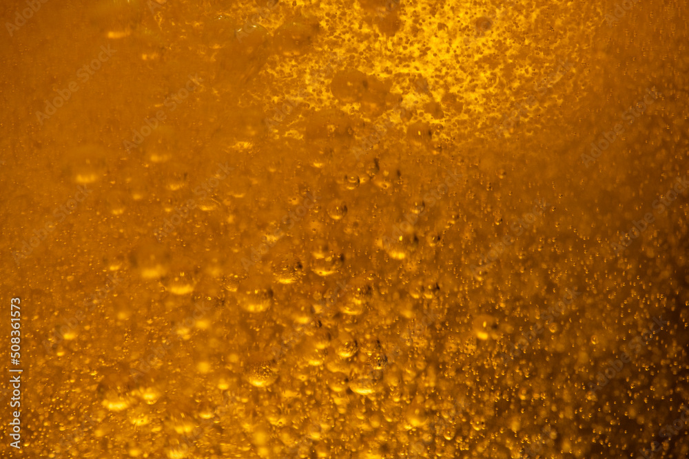 Lager beer bubbles close up motion abstract background