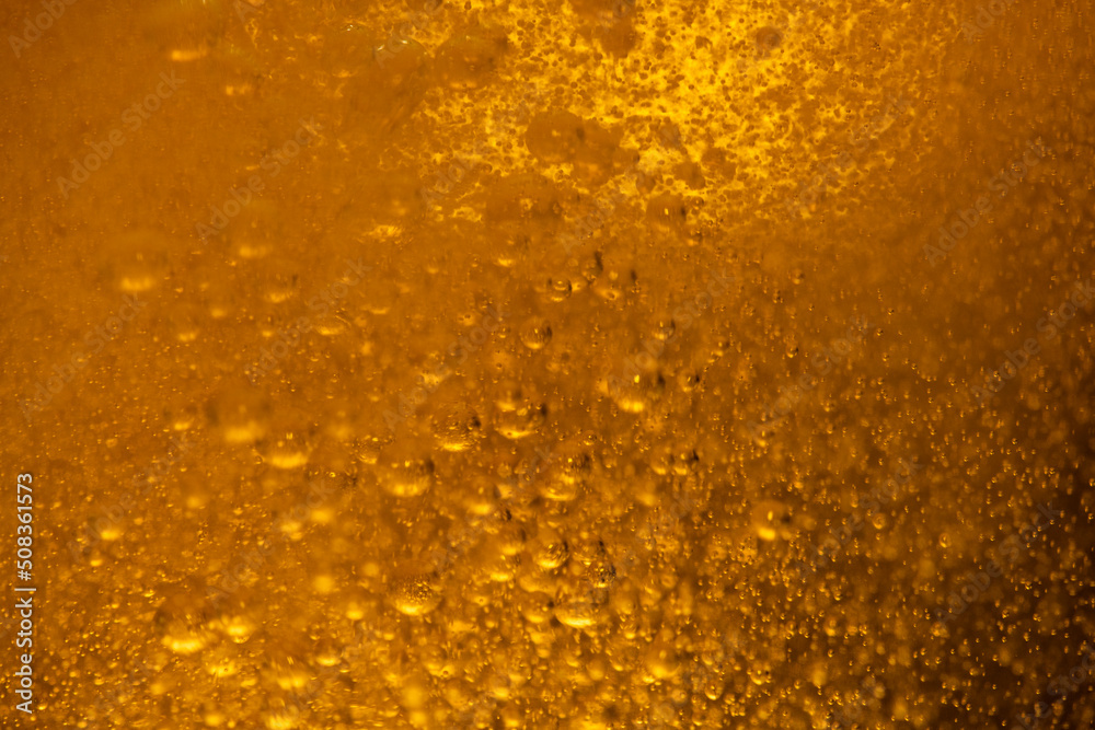 Lager beer bubbles close up motion abstract background Lager beer bubbles close up motion abstract background