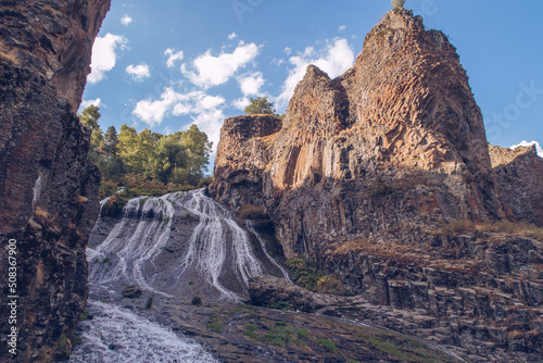 Jermuk waterfall flowing stream picturesque view among the canyon rocks sunlit gorge. Armenian stock photography
