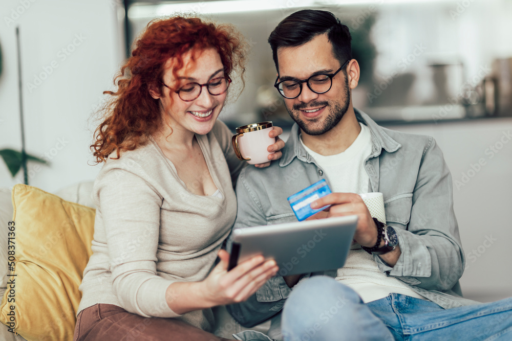 Young couple buying on internet using digital tablet and credit card. Young couple buying on internet using digital tablet and credit card.